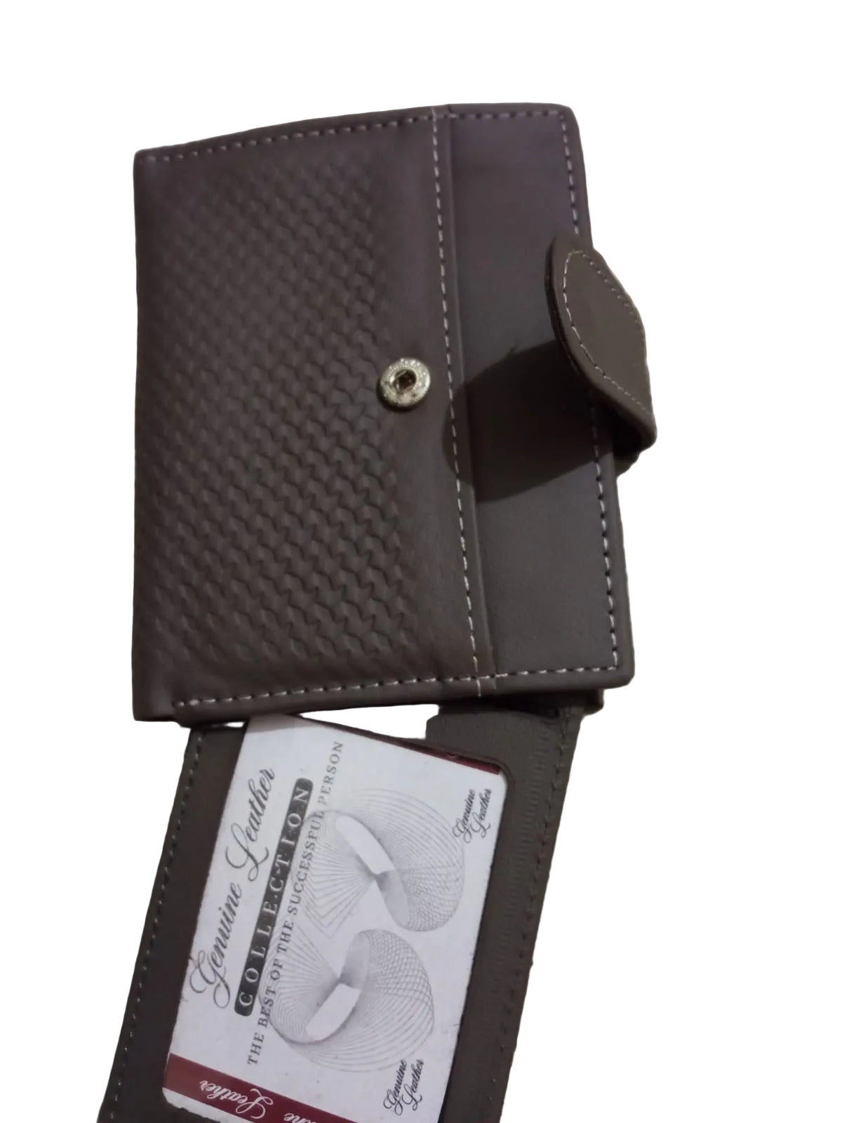 Brown leather wallet with a brand label on a textured surface